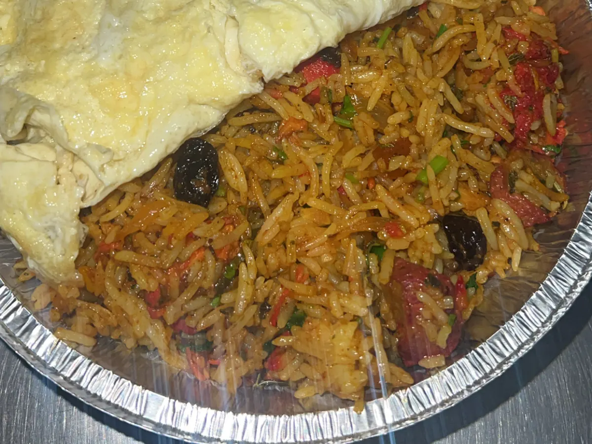 A plate of noodles with meat and vegetables from Tiffin Dronfield in a foil container.